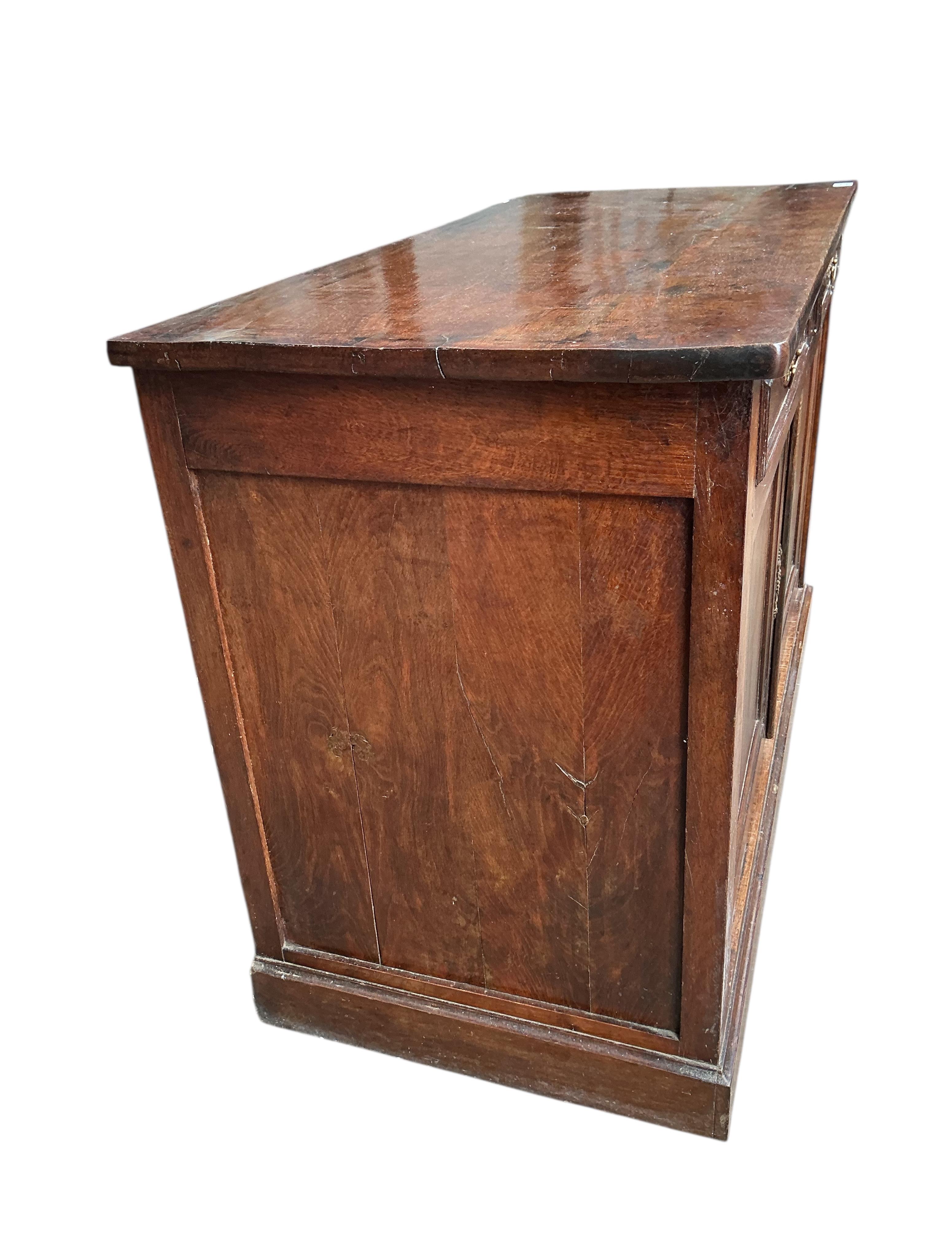 An early 19th century French oak and fruit wood buffet, width 140cm, depth 62cm, height 92cm